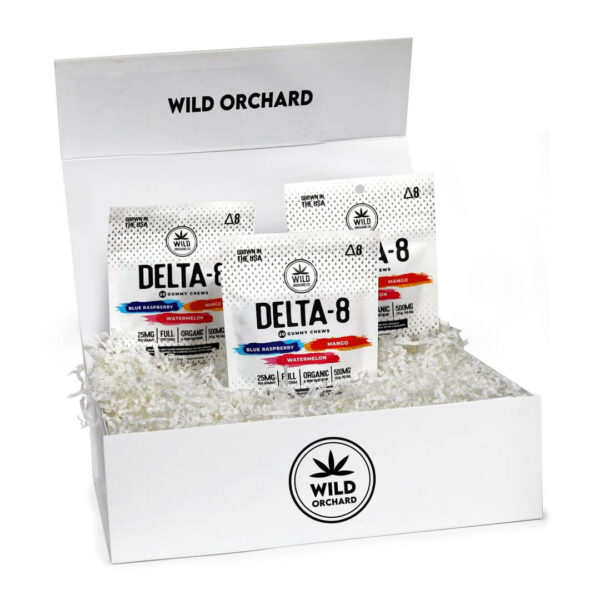 A box of Wild Orchard Delta-8 THC products including a Variety 3-Pack Delta 8 Gummies and several packaged vape cartridges, prominently displayed with the brand logo.